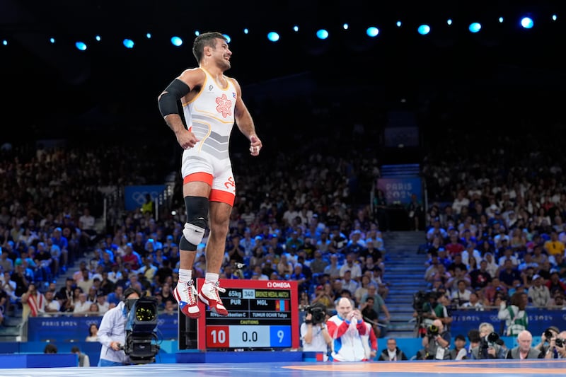 El puertorriqueño Sebastián Rivera celebra después de derrotar a Tumur Ochir Tulga de Mongolia en su combate por la medalla de bronce en la categoría libre masculina de 65 kg en la Arena Champ-de-Mars, durante los Juegos Olímpicos de Verano de 2024, el domingo 11 de agosto de 2024, en París, Francia. (Foto AP/Eugene Hoshiko)